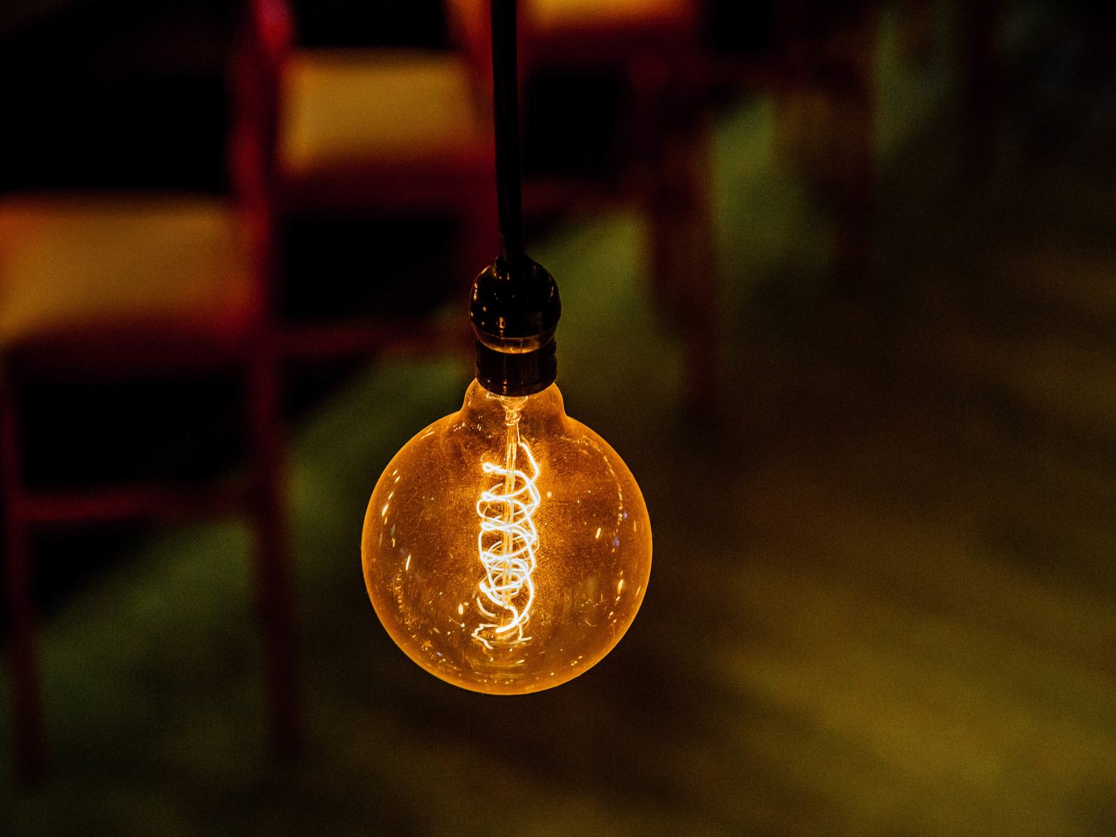 A glowing filament light bulb